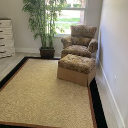 Chair And Ottoman. Rug. Plant 