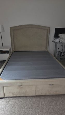 Bed frame with nightstand and dresser.