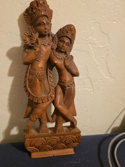 hand-carved wooden statue of the Hindu deities Radha and Krishna