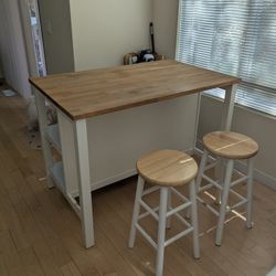 IKEA kitchen island with wood top and 2 shelves and 2 stools