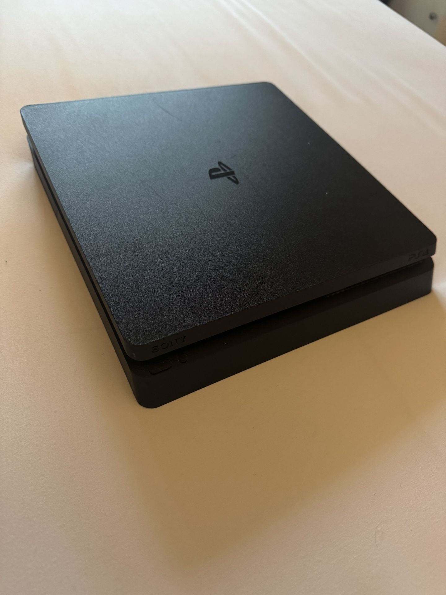 PS4 Slim. Does Not Include Games Or Controllers
