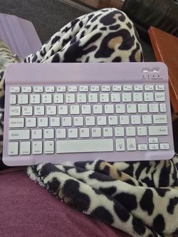 Wireless Bluetooth keyboard in pastel lavender color. Slim and lightweight. Quiet keys. Works with phones, tablets, laptops, and desktops. Great for s