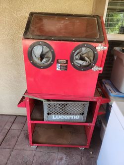 Grit blast cabinet with bucket of glass bead