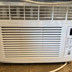 Window A/C unit with plywood board for side windows