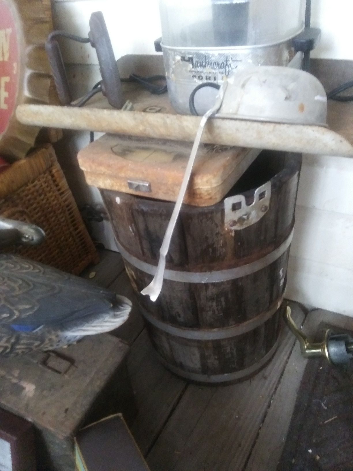Very old wooden barrel with metal ring and plug in bottom