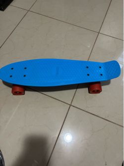 22-inch Penny-Style Cruiser Skateboard Featuring A Bright Blue Plastic Deck And Red Wheels.