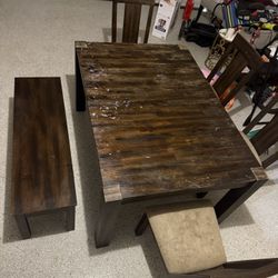 A Dining Table With 4 Chairs And A Bench For Sale