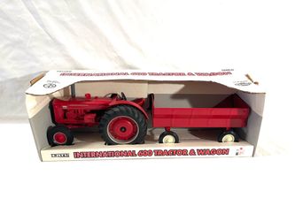 Mint condition still in the box US made by toy maker ERTL scale 1/16 diecast, toy farm, tractor and trailer. Retailed for $78.