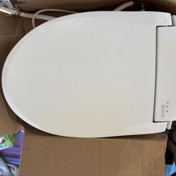 Elongated White  toilet seat with seat warmer ‘ water stream