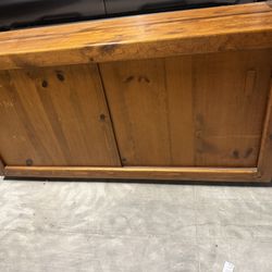 sturdy wood TV console with double sliding cabinet doors 