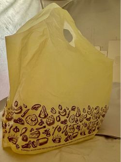 Plastic bags with die cut handle