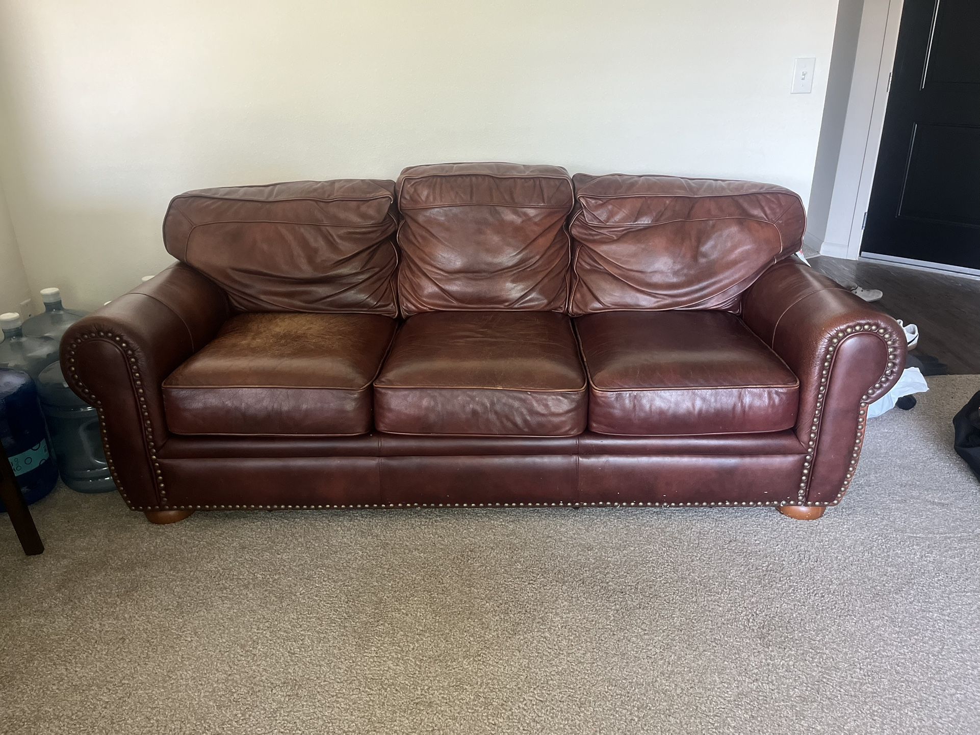 1 Brown leather couch and 2 Brown leather chairs with ottoman