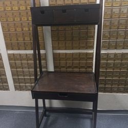 dark wood leaning ladder desk with a single lower drawer and two upper drawers/shelves. 