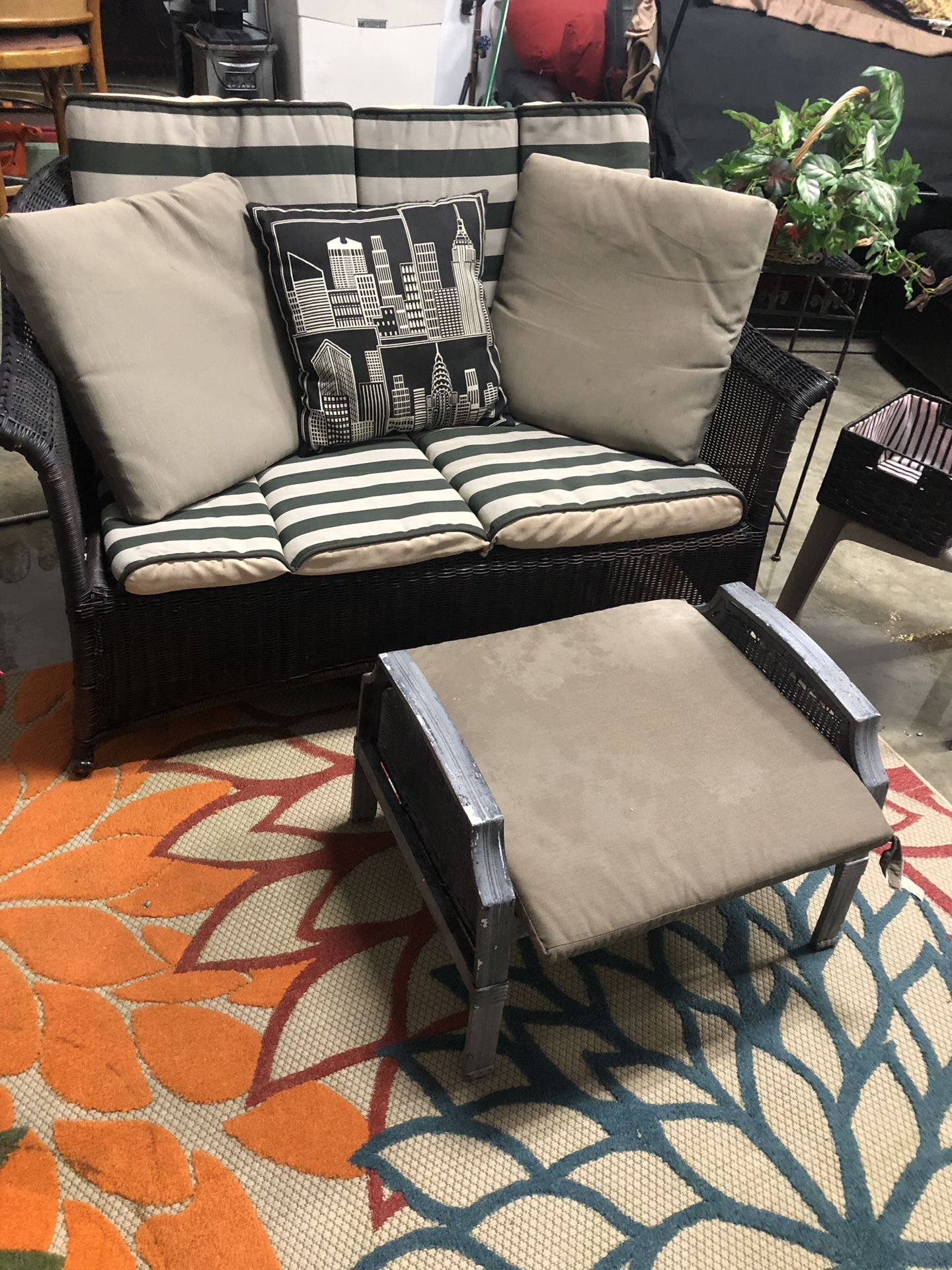 Wicker couch with cushions and ottoman