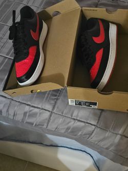 Low top Nike sneakers black and red.
