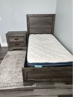 Twin size bed with nightstand. Mattress, rug and new bedding from IKEA are also included. See the pictures.