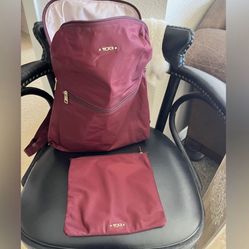 TUMI Just In Case Backpack - Small Travel Bag for Women & Men - Wine/Gold Comes with inside zippered pouch. Measures 19 x 14  New without tags