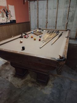 Antique Pool Table with leather pockets.