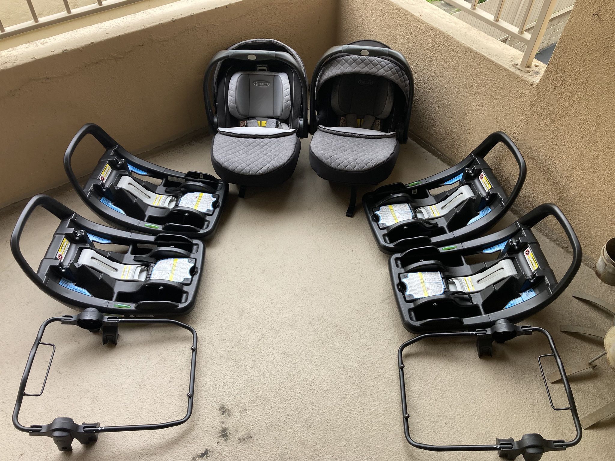 Selling (2) SnugRide® SnugFit 35 Elite Infant Car Seats with (4) bases and (2) stroller attachments.