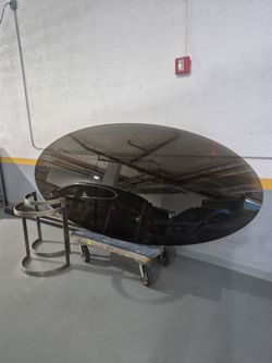 8ft glass oval table..brown glass