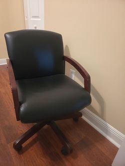 Use something short and buyer-friendly like:

Elegant executive swivel chair with premium black leather and solid wood accents. Comfortable, sturdy, a