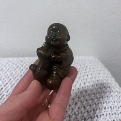 3" by 2" resin hand carved figure of a boy playing with a dog