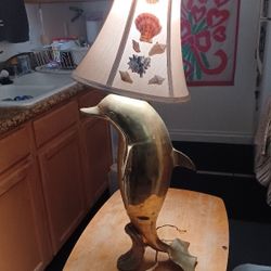 Solid brass dolphin lamp.