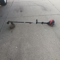 New carburetor tuned Gas-powered Craftsman string trimmer with a 32cc engine. This black and silver tool has a curved shaft design and an adjustable D