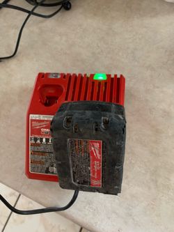 MILWAUKEE RED LITHIUM BATTERY AND CHARGER