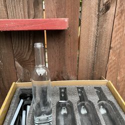 four 750 ml clear glass bottles. 