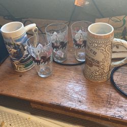 Two beer steins three Budweiser glasses