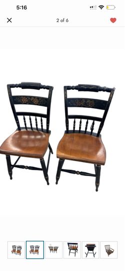 Pair of authentic Hitchcock black and gold accent side chairs featuring a hand-painted floral design