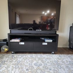 Move out sale:  Dark TV stand with drawers and wheels