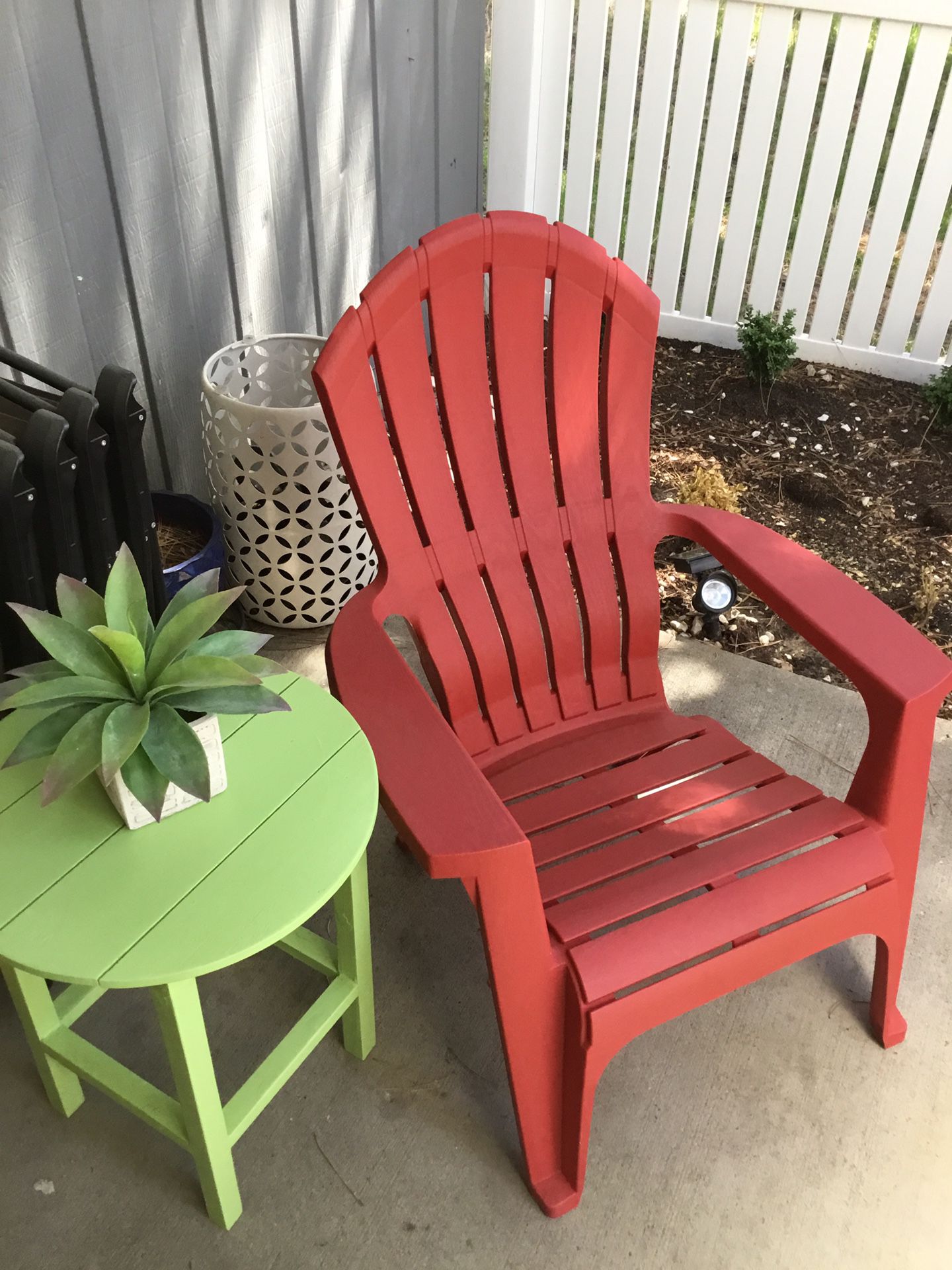 Red Adirondack chair and side table