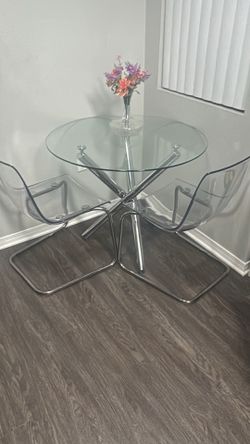 Glass table top with chrome legs/ set of two IKEA ghost chairs