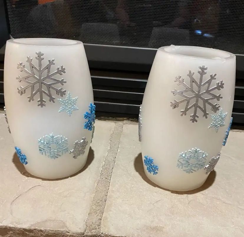 Set of two candle holders with snowflake design.