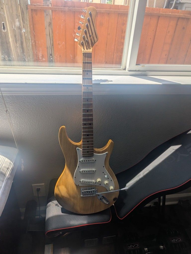 Stratocaster Style Guitar With A Custom Wood Finish.