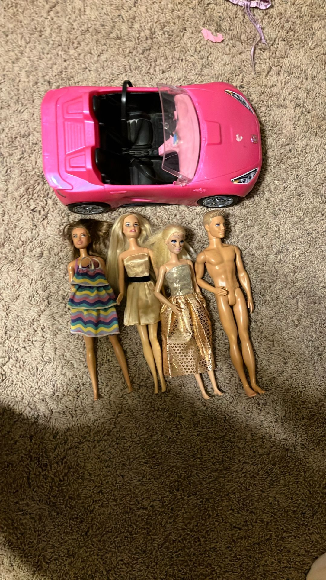 Lots of Barbie dolls, and car