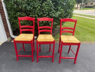 3 red counter-height stools
