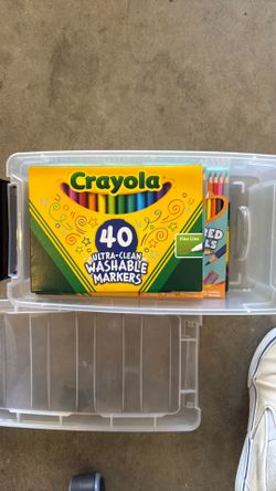 New markers and colored pencils and bin