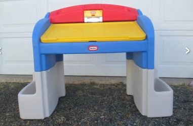 Little Tikes Hideaway Art Desk features a vibrant blue, red, and yellow design with a large drawing surface