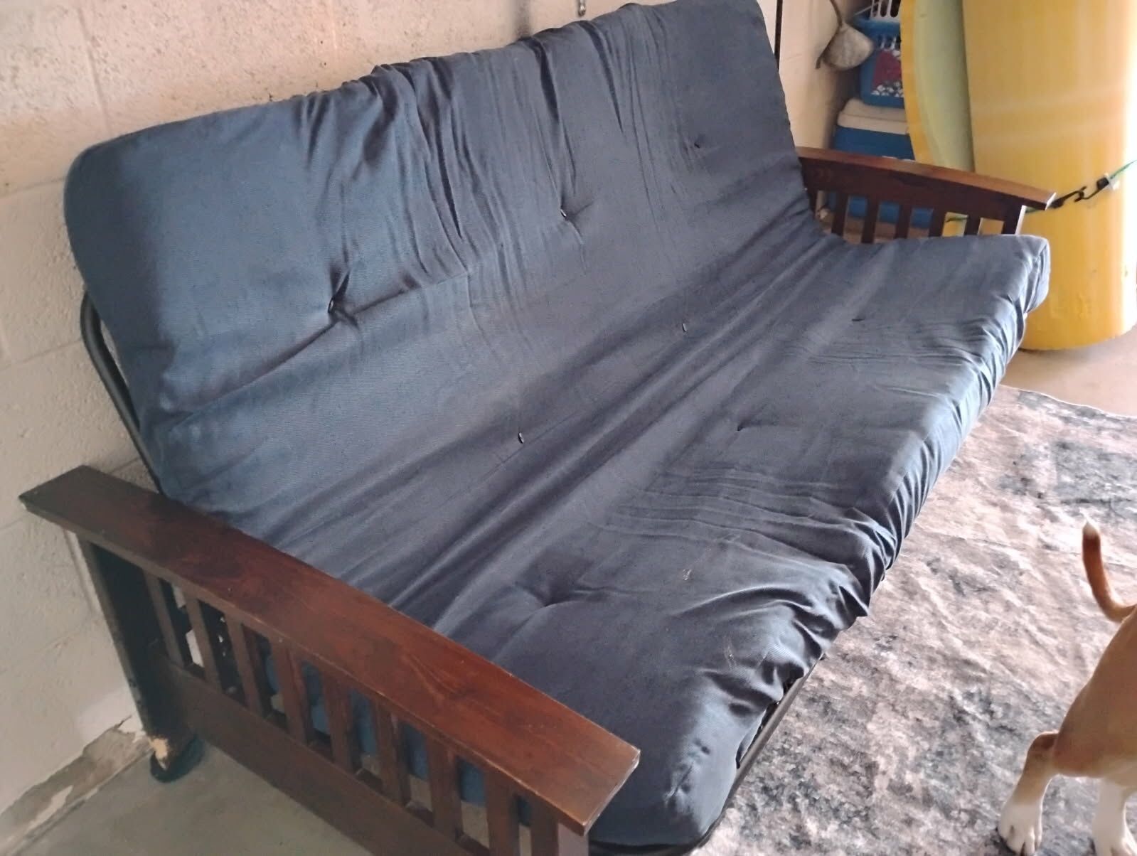 Nice Dark Wood Futon (Please read entire post) Less than 2 years old, has an upgraded 4" cushion, Navy Blue. Functions fine. *Please note: puppy