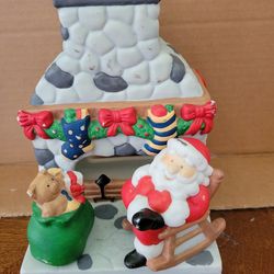 PARTYLITE Christmas Santa Claus figurine Christmas sculpture. Santa by fireplace with present.