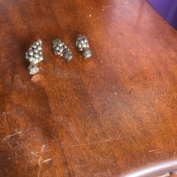 The object in the image is a grape cluster finial. A finial is an ornamental attachment used to decorate the ends of items such as lamp stands, curtai