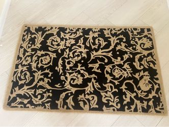 Handmade Rug 65” X 41”. Well made rug in beige and black. Perfect condition No smoke or pets