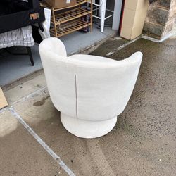 Modern cream swivel accent chair with pillow