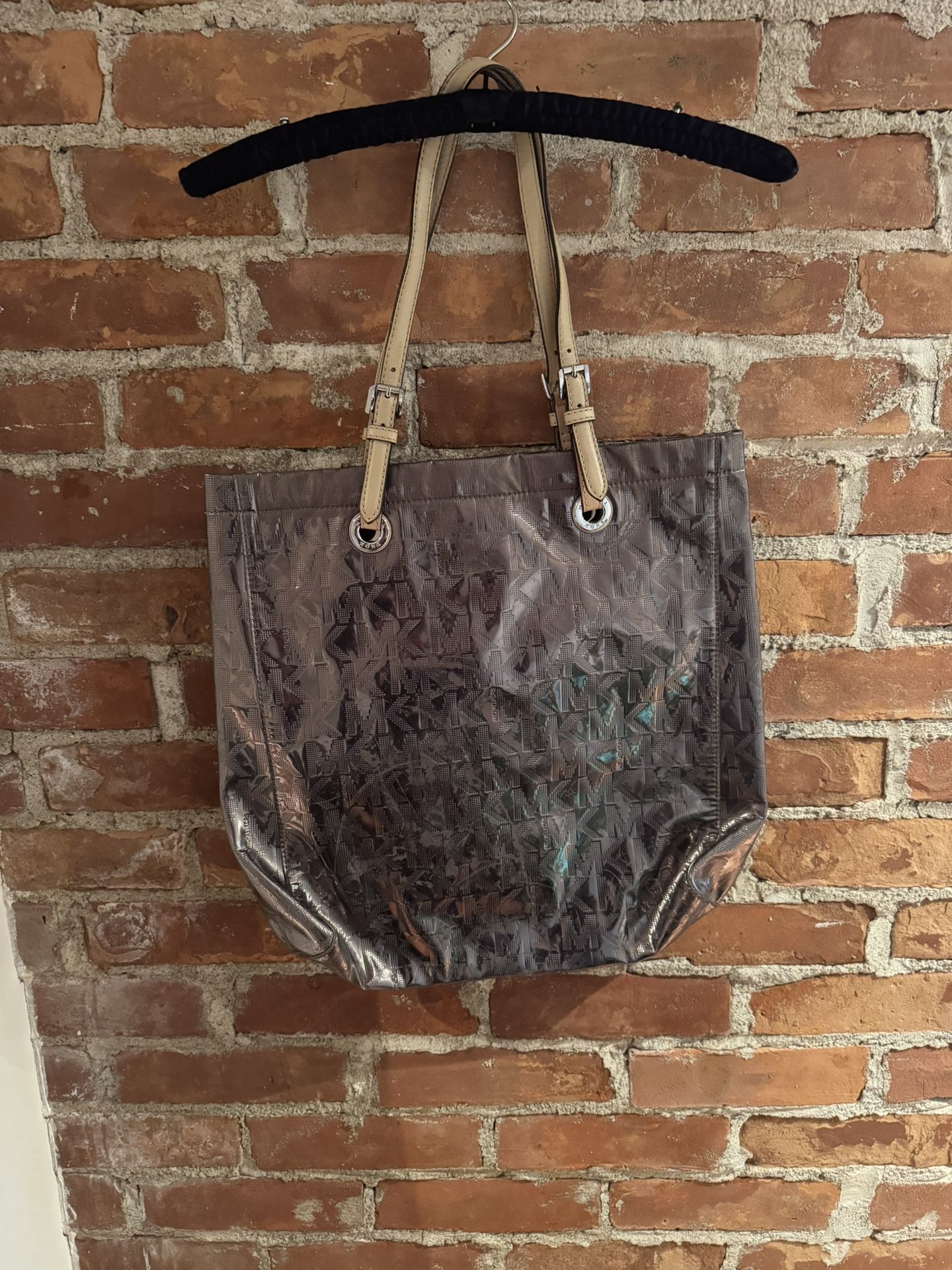 Authentic Michael Kors tote Metallic has worn on bag please see photos Inside bag in perfect condition