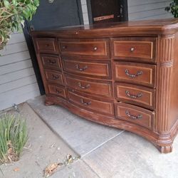 Beautiful solid wood dresser with a rich brown finish and elegant curved front.