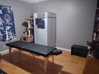 Massage table (not used) with accessories.