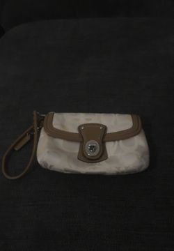 Cream and brown Coach wristlet